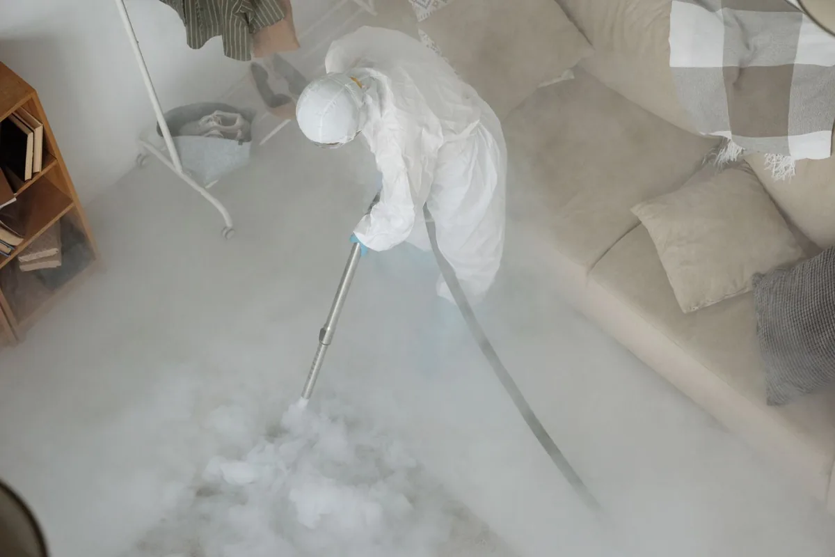 Biohazard cleanup technician in protective equipment, Bennett, CO
